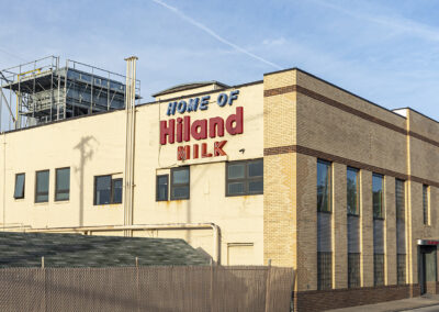 Building at the Hiland Dairy, Omaha location showing a vintage neon sign that says "Home of Hiland Milk"
