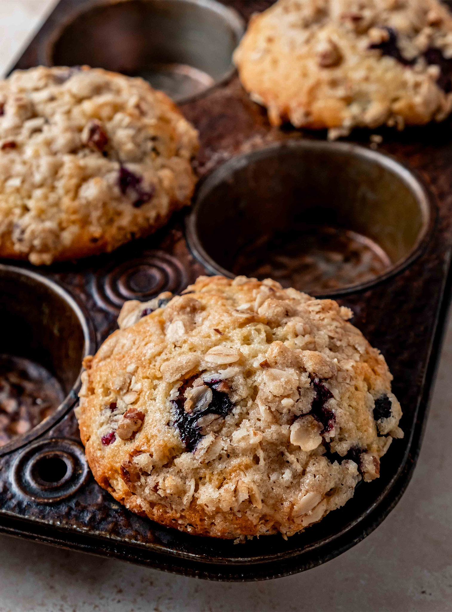 Blueberry Streusel Muffins in a muffin pan after baking