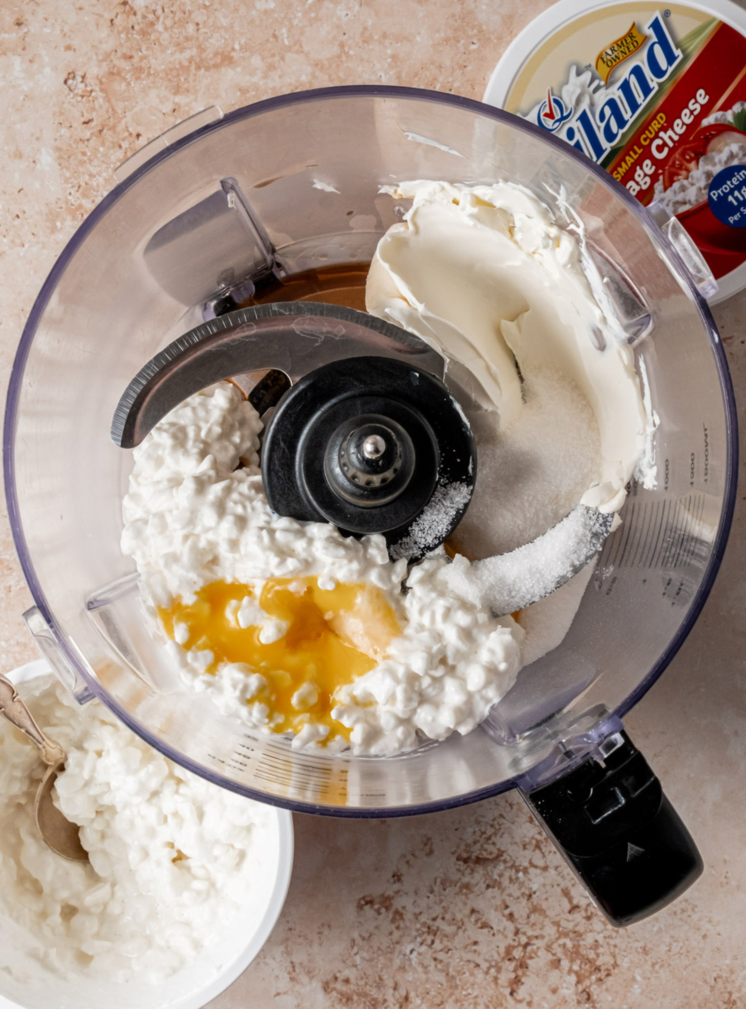 Cottage Cheese, Cream Cheese, sugar, vanilla extract and an egg yolk in a food processor