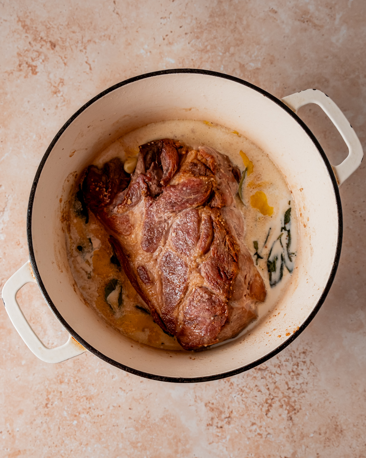 Pork shoulder marinating in Lactose Free milk with spices