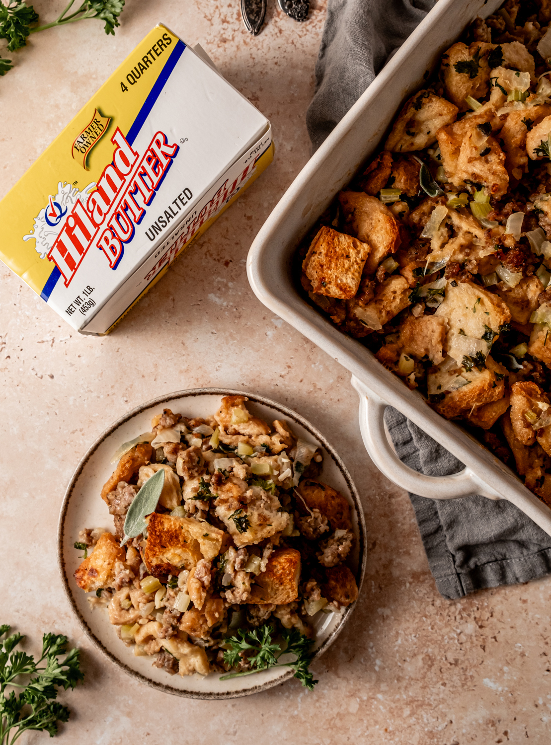 A box of Hiland butter, beside a serving of sausage and sage stuffing on a plate, showcasing the final dish.