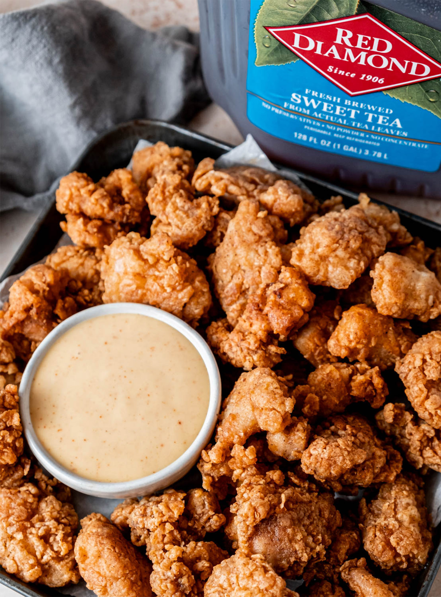 Sweet Tea Popcorn Chicken with a ramekin of dipping sauce